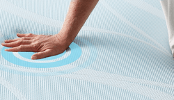 Hand experiencing the cool-to-touch power of Breeze mattresses