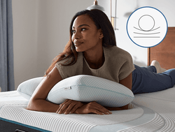 woman laying on tempurpedic comfort pillow with an icon demonstrating a classic shape