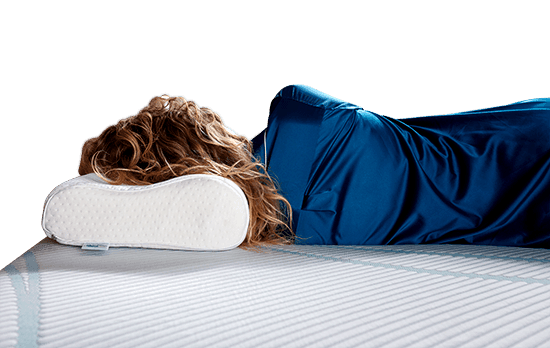 a woman laying on the Tempur-Neck pillow on a Tempur-Pedic mattress