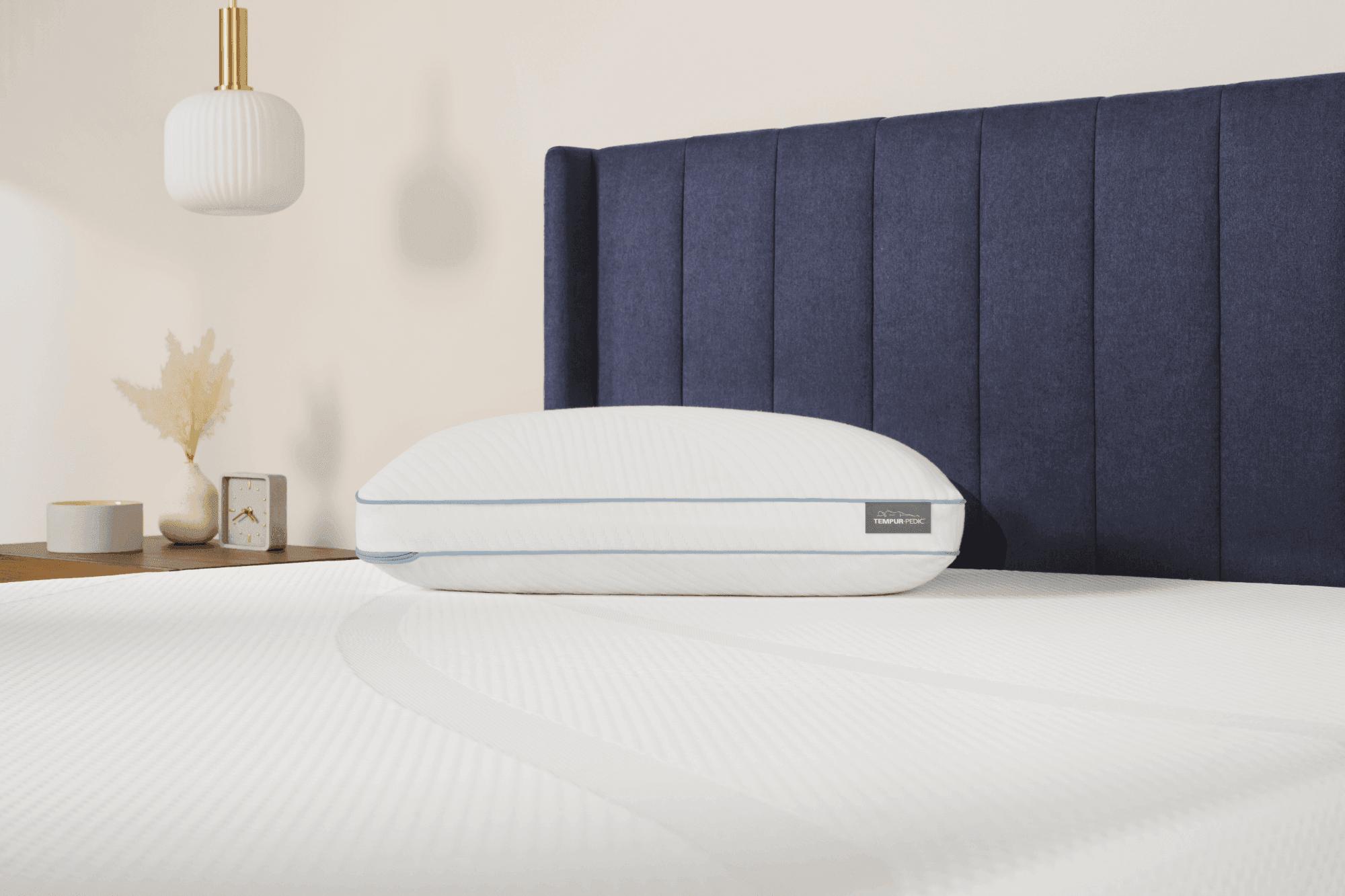 A Tempur Cloud Hybrid pillow laying on a Tempur Pedic mattress